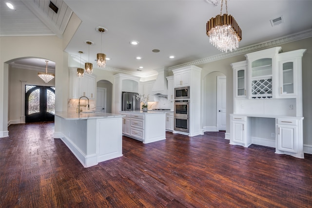 unfurnished living room with dark hardwood / wood-style flooring, vaulted ceiling, and ornamental molding