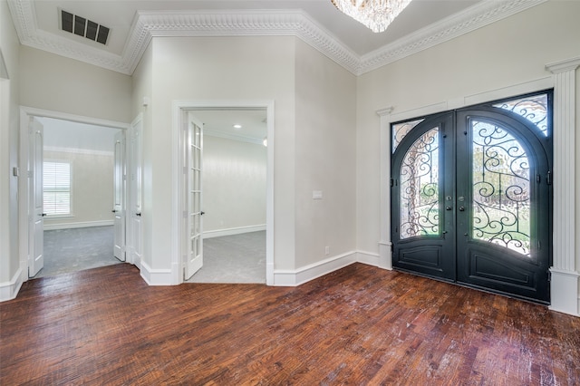 carpeted empty room featuring crown molding and an inviting chandelier