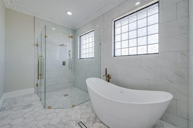 bathroom featuring vanity, tile patterned floors, vaulted ceiling, ornamental molding, and tile walls