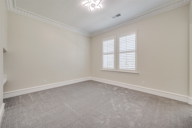 spare room featuring light colored carpet and ornamental molding