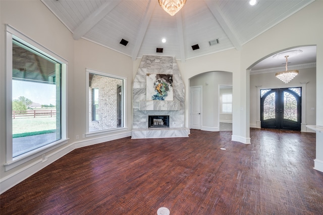 unfurnished living room with beam ceiling, a high end fireplace, and dark hardwood / wood-style floors