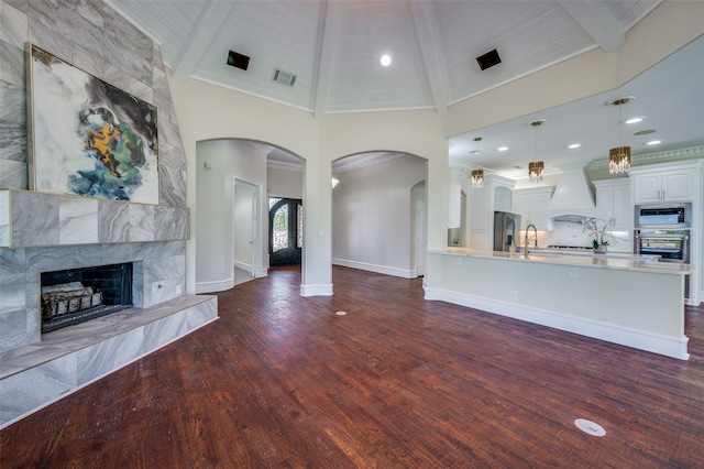 kitchen featuring french doors, tasteful backsplash, decorative light fixtures, white cabinets, and appliances with stainless steel finishes