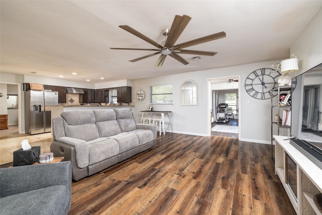 living room with ceiling fan and dark hardwood / wood-style floors