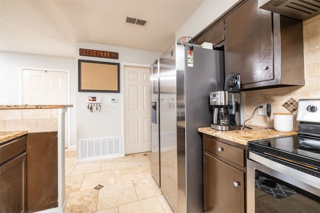 kitchen with tasteful backsplash, light tile patterned flooring, range hood, electric stove, and dark brown cabinetry