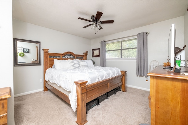 bedroom with ceiling fan and light carpet