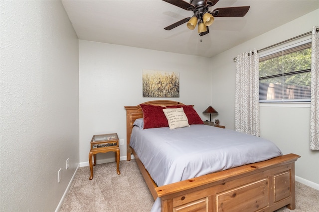 bedroom with light carpet and ceiling fan