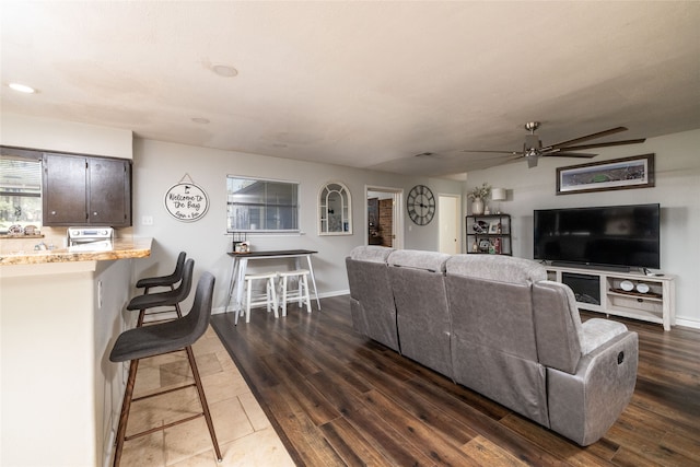 living room with ceiling fan and dark hardwood / wood-style floors