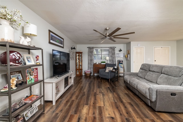 living room with dark hardwood / wood-style flooring, a textured ceiling, and ceiling fan