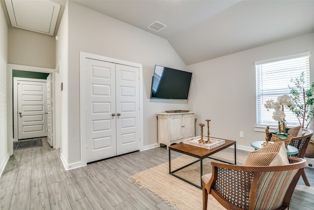 living room featuring light hardwood / wood-style floors and vaulted ceiling