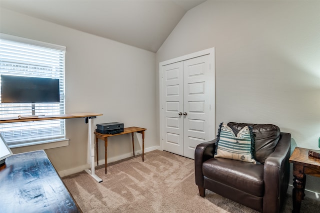 sitting room featuring light carpet and lofted ceiling