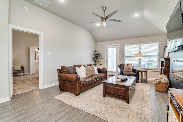 living room featuring lofted ceiling, ceiling fan, and light hardwood / wood-style floors