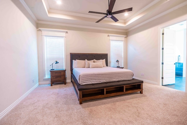 carpeted bedroom with a raised ceiling, crown molding, and ceiling fan