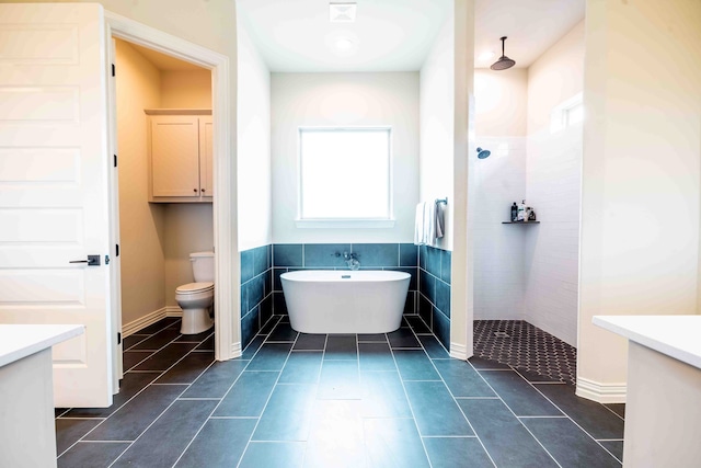 full bathroom with vanity, tile patterned floors, tile walls, and separate shower and tub