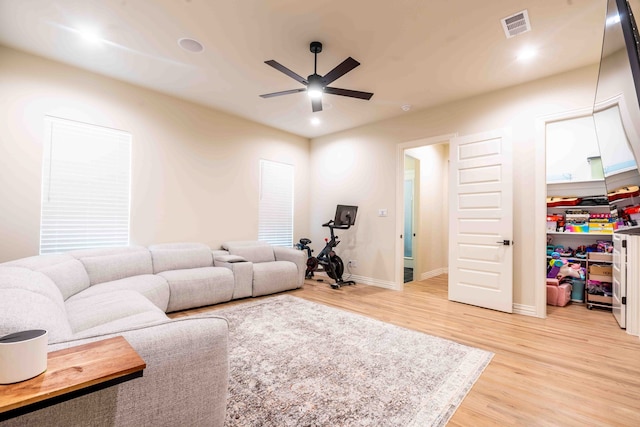 living room featuring hardwood / wood-style floors and ceiling fan