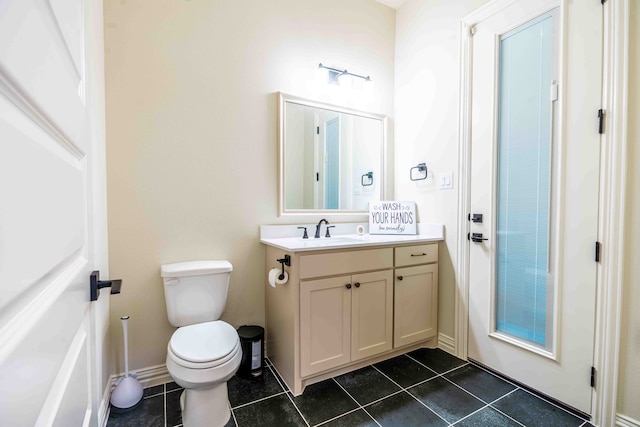 bathroom with vanity, tile patterned floors, and toilet