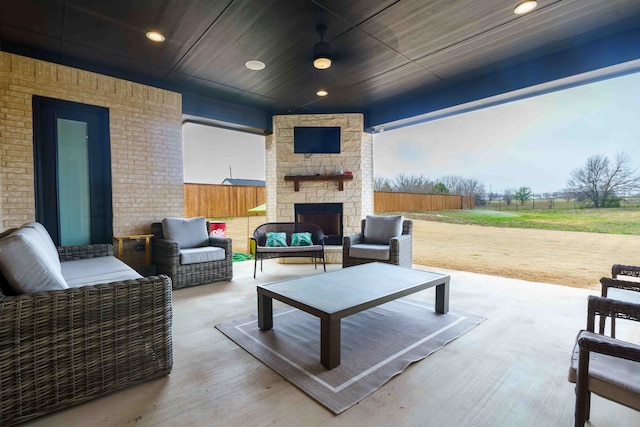 view of patio / terrace with an outdoor living space with a fireplace