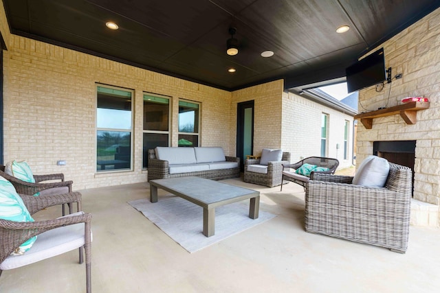 view of patio featuring an outdoor living space with a fireplace