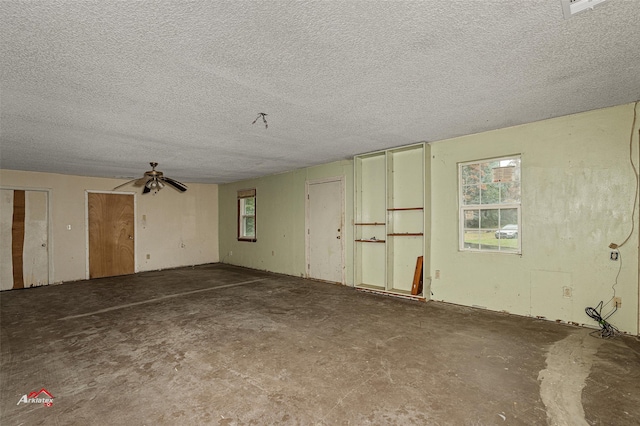 interior space with a textured ceiling and concrete floors