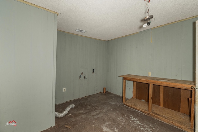 unfurnished room with a textured ceiling