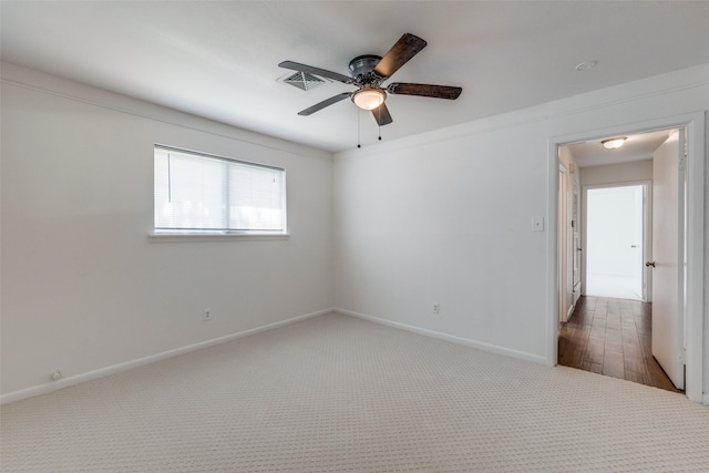 empty room with ceiling fan and carpet