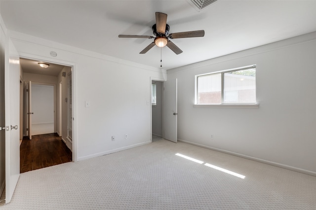 unfurnished room with ceiling fan and carpet floors