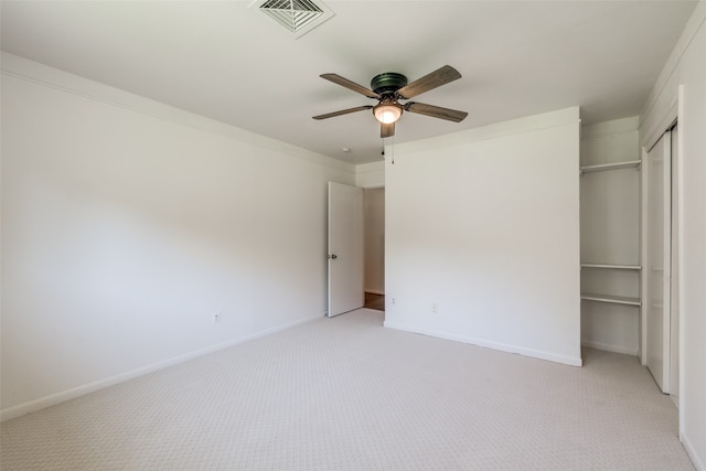 unfurnished bedroom with ornamental molding, light carpet, and ceiling fan