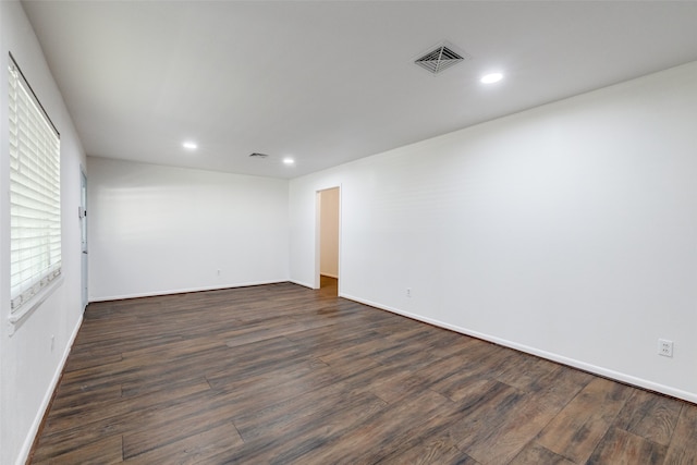 empty room with dark hardwood / wood-style flooring