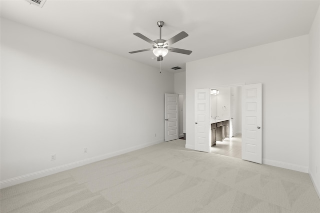 unfurnished bedroom featuring light carpet, visible vents, ceiling fan, and baseboards