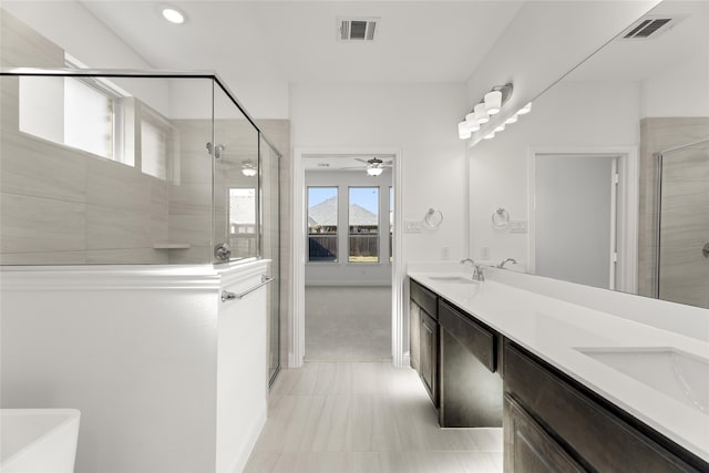 bathroom featuring a sink, visible vents, a stall shower, and double vanity