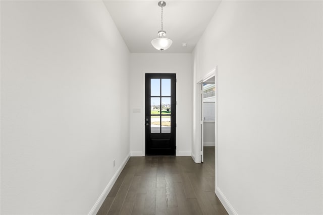 entryway featuring dark wood-style floors and baseboards