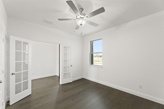 unfurnished room featuring visible vents, french doors, baseboards, ceiling fan, and dark wood-style flooring