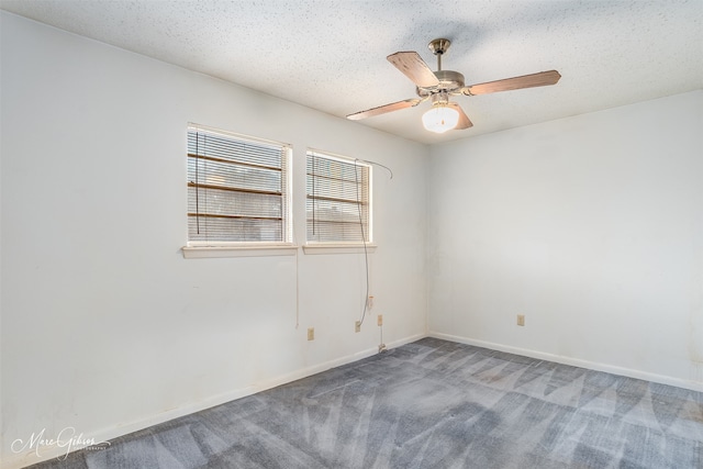 carpeted empty room with ceiling fan and a textured ceiling