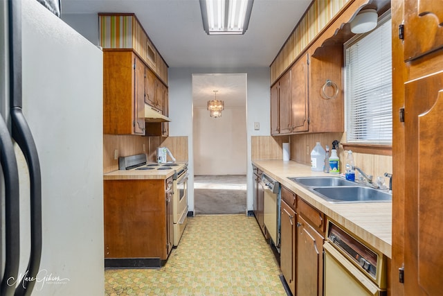 kitchen featuring dishwasher, range with electric cooktop, white fridge, and sink