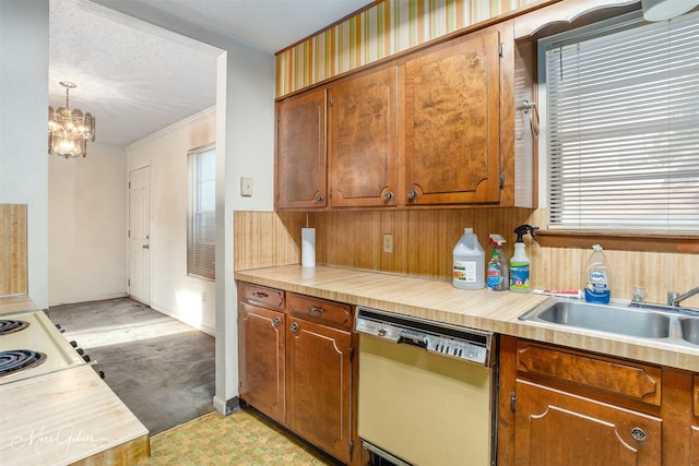 kitchen featuring dishwashing machine, a textured ceiling, crown molding, an inviting chandelier, and decorative light fixtures