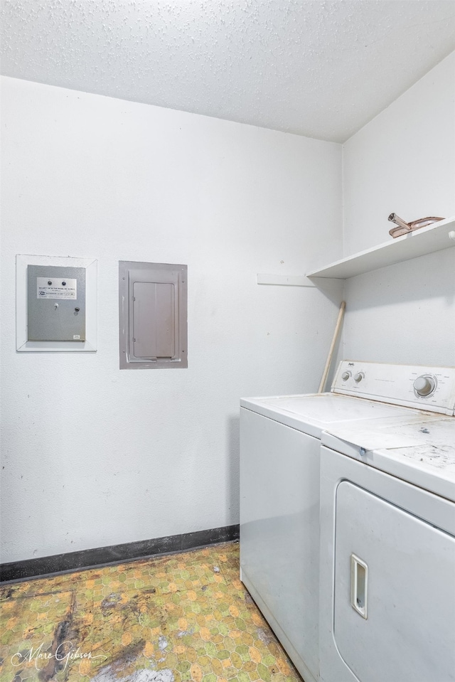 laundry area featuring electric panel, independent washer and dryer, and a textured ceiling