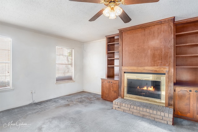 unfurnished living room featuring a textured ceiling, a fireplace, ceiling fan, and light colored carpet