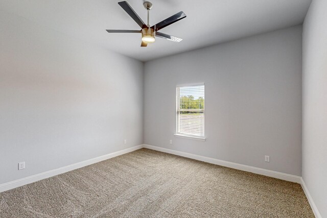 empty room with ceiling fan and carpet floors