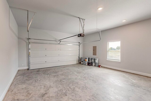 garage featuring electric panel and a garage door opener