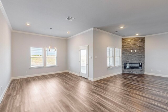 unfurnished living room with hardwood / wood-style flooring, a fireplace, and crown molding