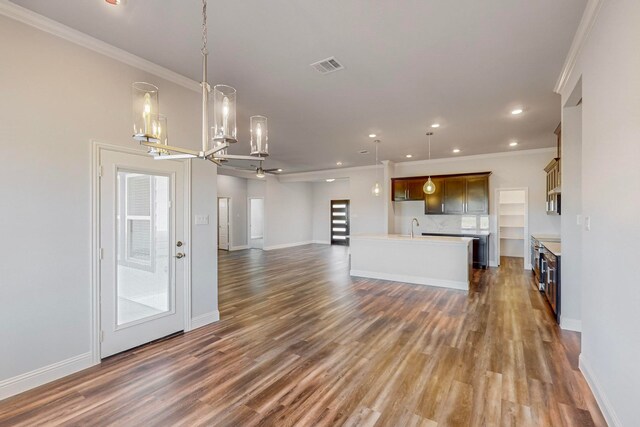 kitchen featuring pendant lighting, dark hardwood / wood-style floors, and ornamental molding