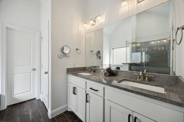 bathroom with hardwood / wood-style floors, lofted ceiling, vanity, and a shower with shower door