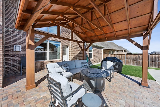 view of patio / terrace with an outdoor living space with a fire pit and a grill