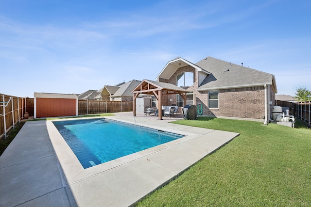 view of pool with a gazebo, a yard, a storage unit, and a patio