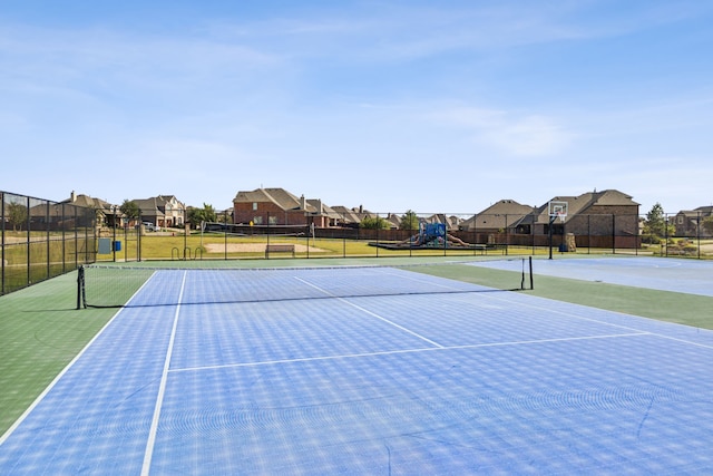 view of sport court featuring a playground