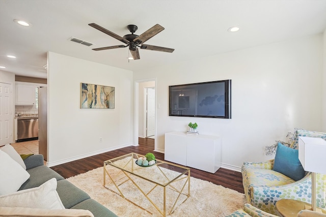 living room with hardwood / wood-style flooring and ceiling fan