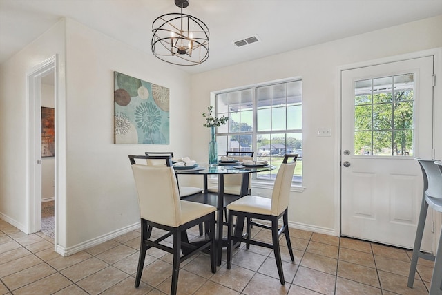 dining space with a notable chandelier and light tile patterned floors