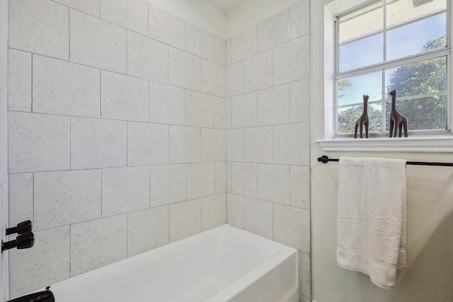 bathroom with a tub and a healthy amount of sunlight