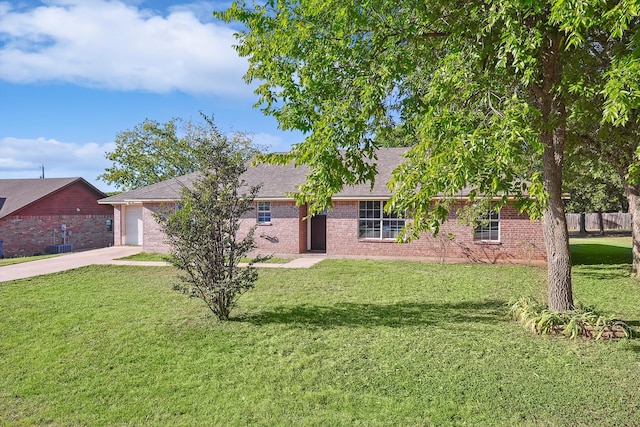 view of front of house featuring central AC unit, a garage, and a front lawn