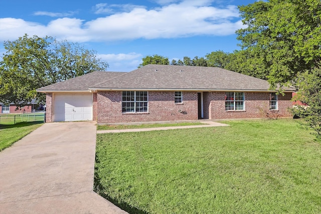 ranch-style house featuring a garage and a front lawn