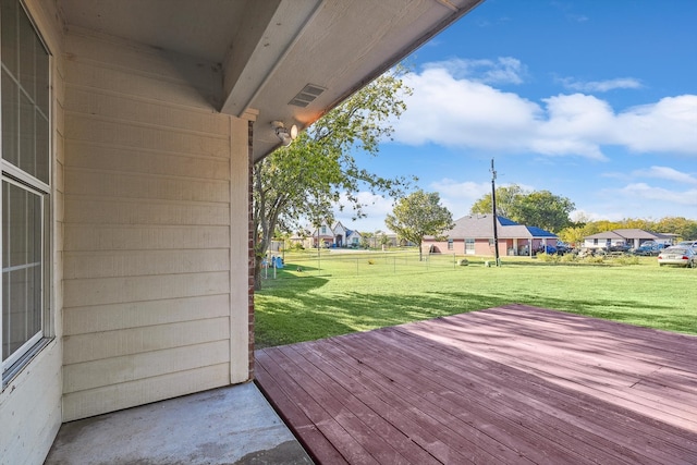 wooden deck featuring a yard